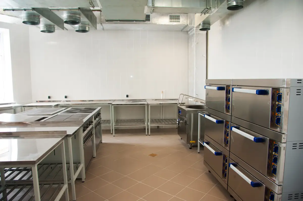 Empty commercial kitchen with stainless equipment already in place